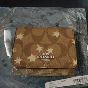 Coach signature tri fold wallet sold**